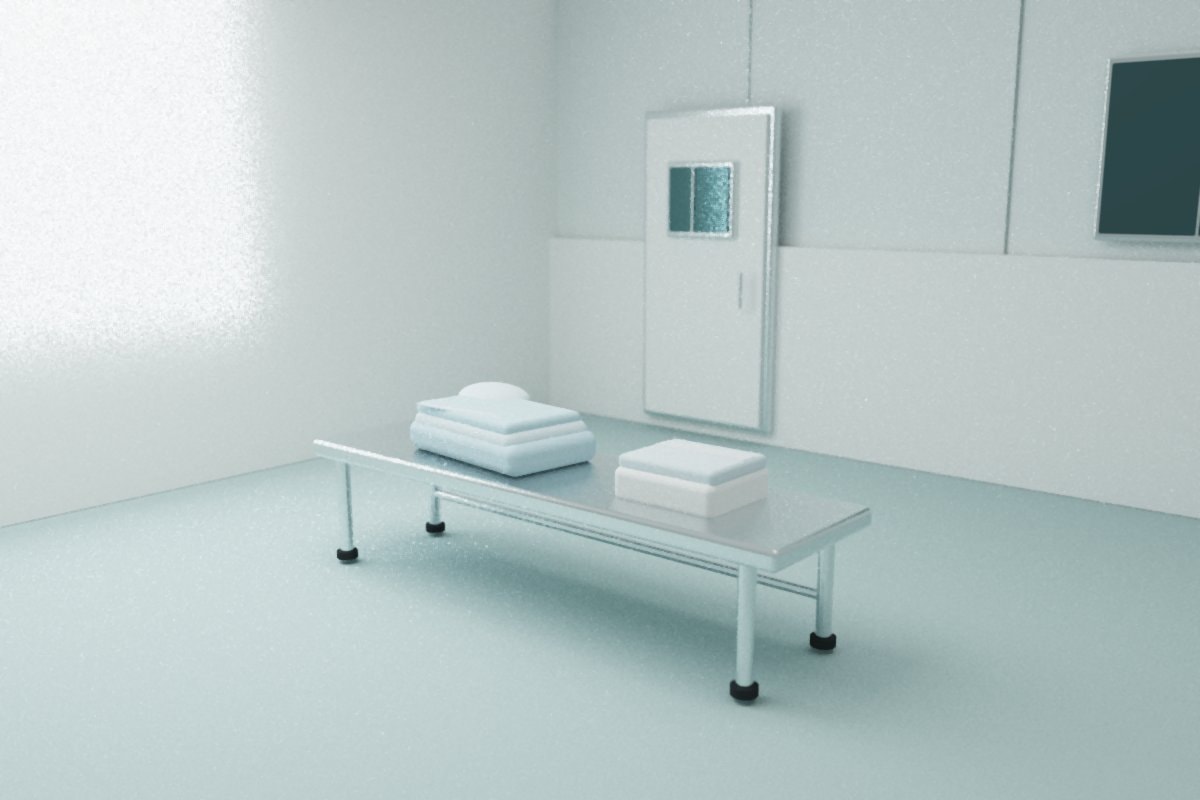 Folded pale blue garments on a stainless bench in an empty gowning room